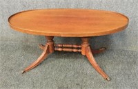 Oval Wood Coffee Table w/Trestle Carving on Feet