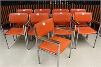 9 bright orange arm chairs made by Howell