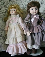 2 Porcelain Dolls (one in pink dress has a broke f