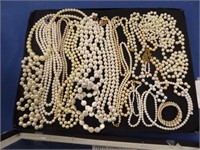 TRAY OF FAUX PEARL STRAND WOMANS NECKLACES.