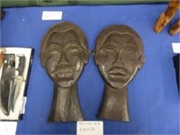 TWO EBONIZED WOOD BUST CARVINGS OF A MAN AND