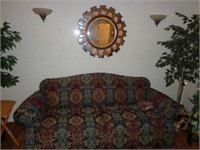 Upholstered Sofa & Round Mirror on Wall