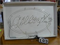 Gilleys red neon sign mounted in white wood frame