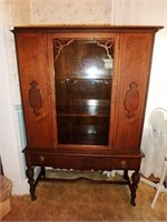 Walnut china cabinet with single glass door with