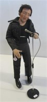 Elvis Presley doll on stand with microphone