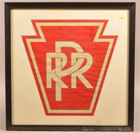 PRR keystone framed reflective red emblem.