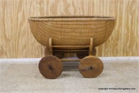 Antique Wicker Bassinet on Wooden Roller Cart