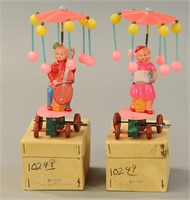 TWO BOXED MECHANICAL CELLULOID WHIRLIGIG TOYS