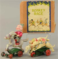 TWO MECHANICAL CELLULOID RACE FIGURES