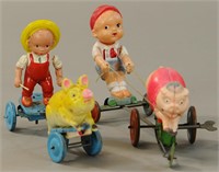 PAIR OF CELLULOID BOY IN MECHANICAL CART TOYS