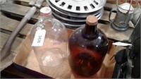 2 One gallon glass jars, brown and clear