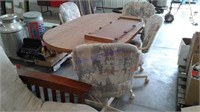 Table with 2 12 inch leaves and 4 rolling chairs