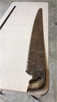Solid saw with wood handle.