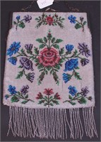 A large beaded purse decorated with roses