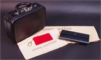A black Louis Vuitton box purse with gray clutch