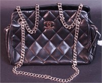 A black quilted leather bag marked Chanel Made In