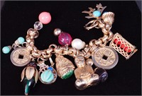 A Napier costume bracelet with charms in goldtone