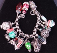 A costume bracelet marked Napier with charms