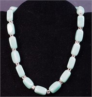 A green-colored stone necklace