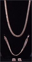 A silver necklace, bracelet and pierced