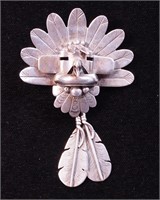 An silver pendant of bird head with feathers