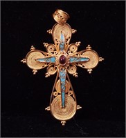 A yellow gold crucifix with turquoise