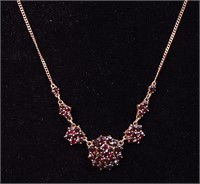A 14K yellow gold necklace with garnets