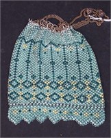 A seafoam colored enameled steel mesh purse