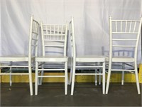 4 white, metal chairs