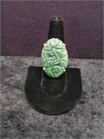 Relief carved jade stone ring in gold toned settin