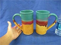 2 medium signed pottery mugs - 7in tall