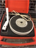 Portable 45 RPM record player in bright orange,
