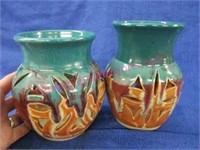2 pottery candleholders (signed)
