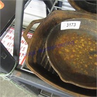 Pair of cast iron skillets, rusted