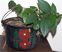 decorated cast iron pot with 3 feet