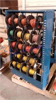 Rack w/ 19 partial spools asst electrical wire