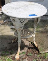 2 marble top tables with ornate cast iron bases,