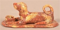 Glazed Redware Figure of a Recumbent Dog with Bask