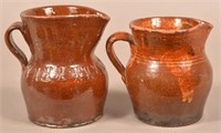 Two Glazed Redware Pottery Pitchers.