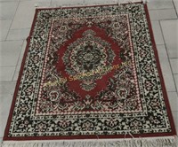 RED, GREEN AND CREAM WOOL ORIENTAL CARPET