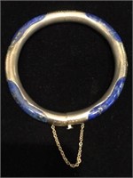 Silver bangle with blue accent stones