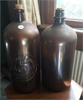 Brown medicine bottles, label raised in glass