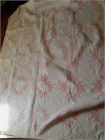 Pink and white homemade quilt