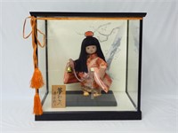 Japanese Doll Holding Bell in Glass Case