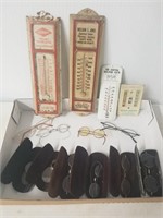 Lot of advertising thermometers and eyeglasses