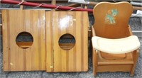 pair of cornhole boards and a child's potty