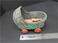 Vintage miniature baby doll in wicker buggy toy