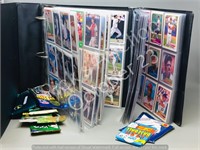 baseball cards in binder and 14 unopened packs of