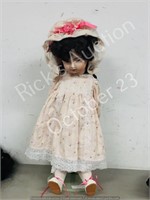 27" tall porcelain doll w/ stand (curly hair)