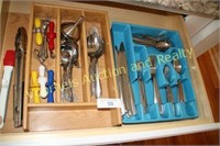 Drawer of stainless steel flatware, serving pieces